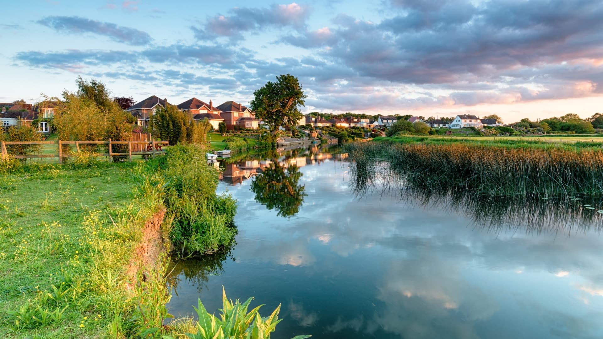 A small river or canal with trees and houses